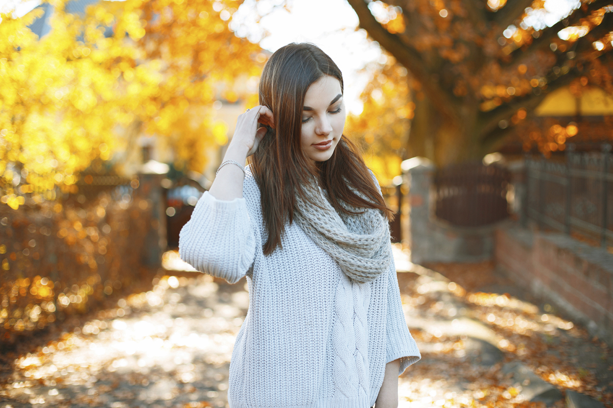 Beautiful girl in a knitted sweater on the background of a beaut