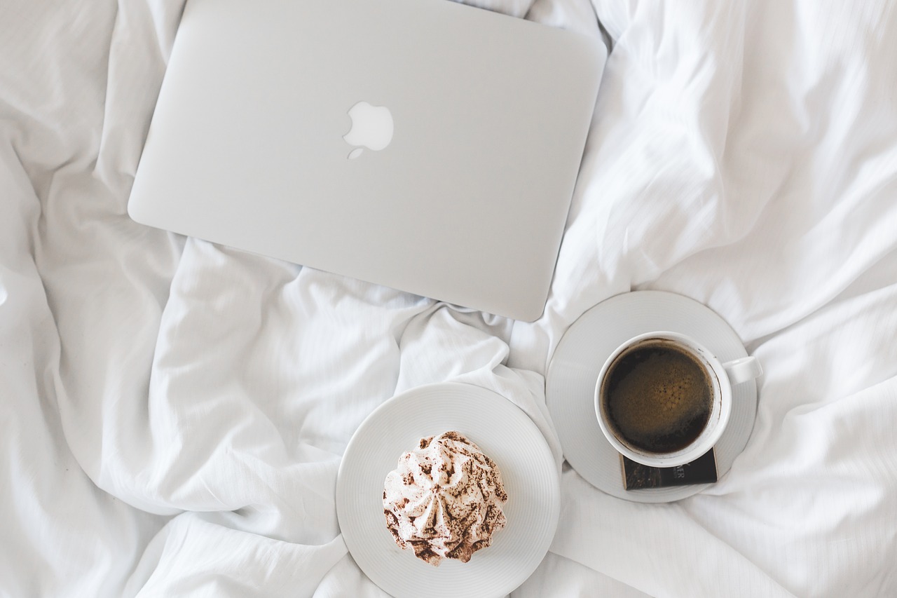 coffee and laptop hotel bed