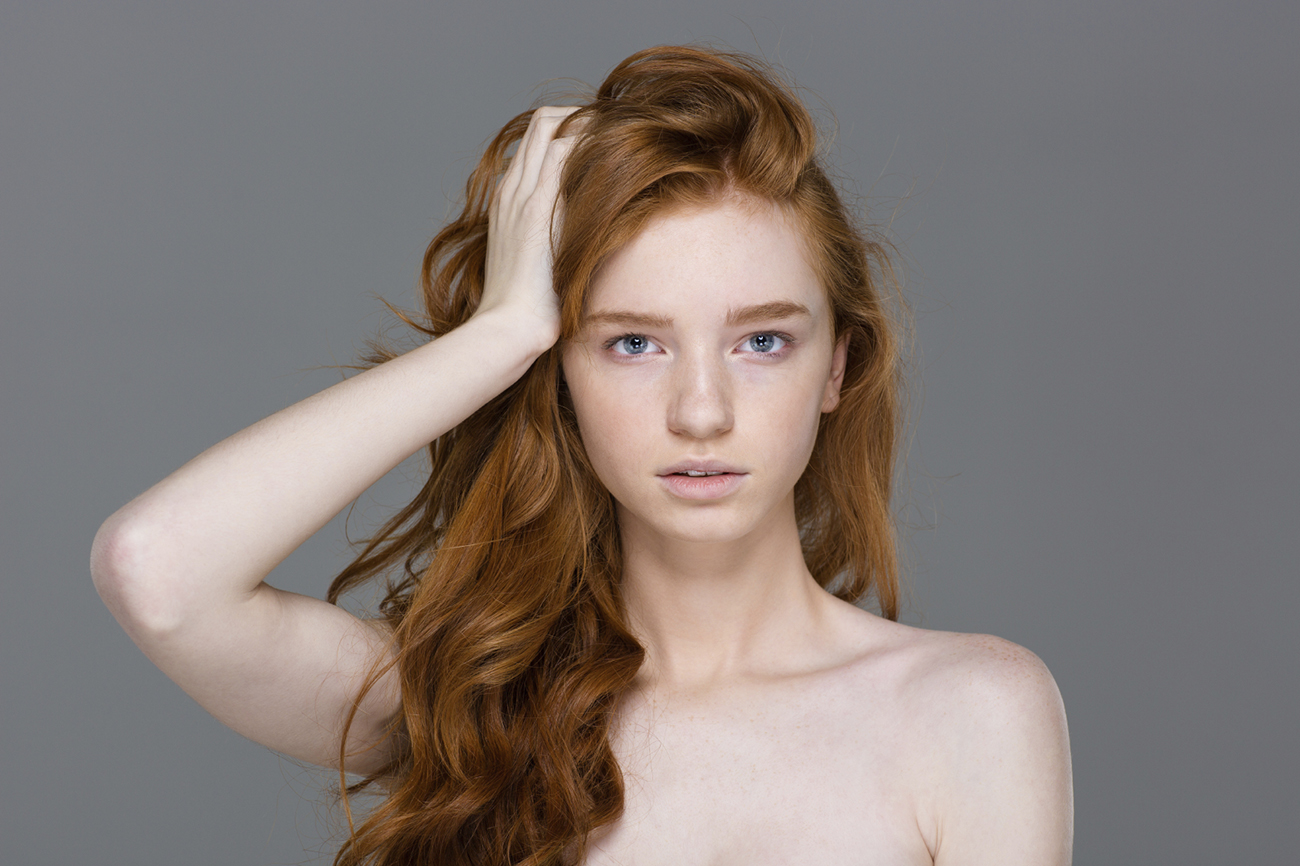 Beauty portrait of tender woman with beautiful long red hair