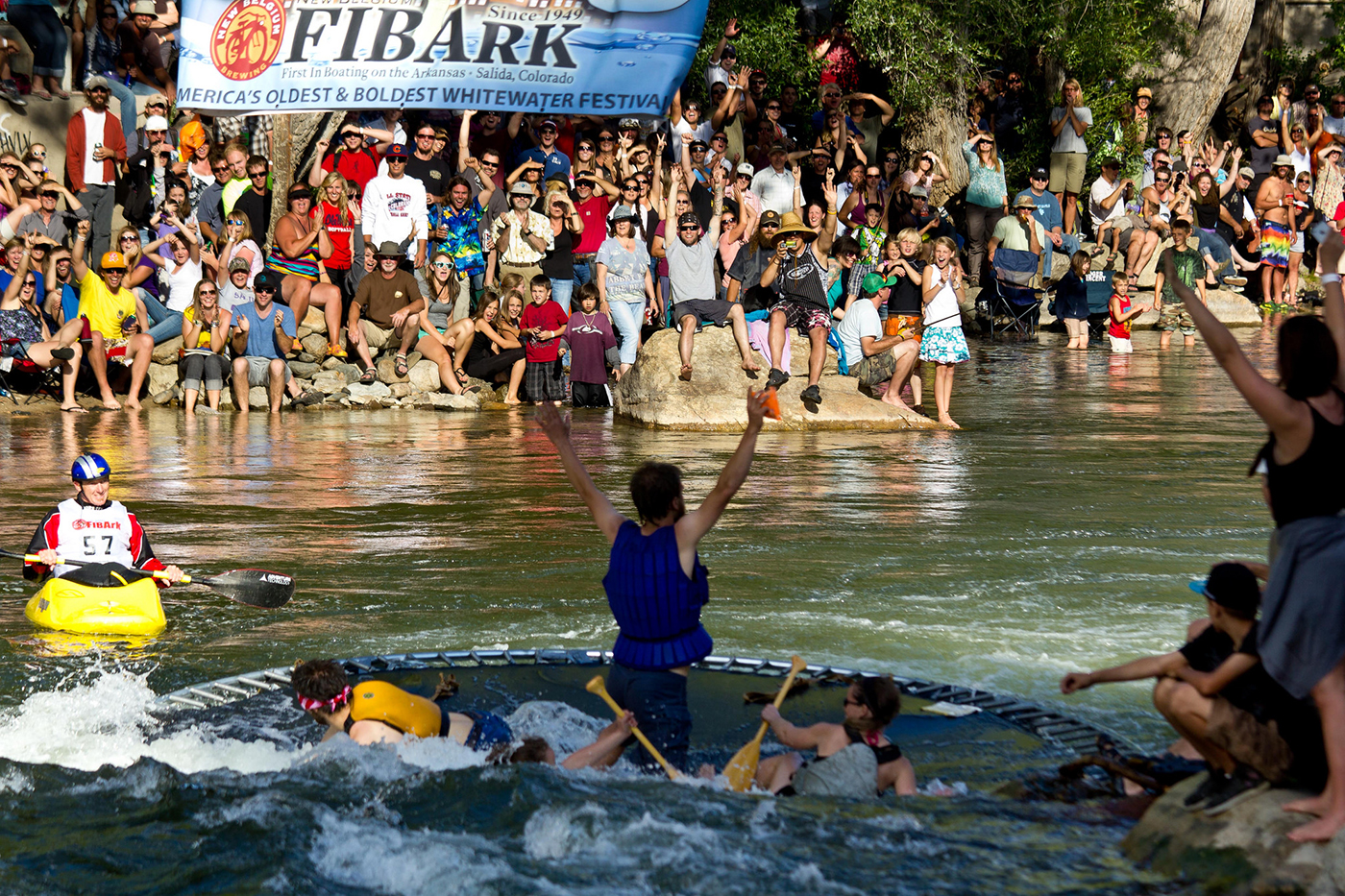 A team member celebrates after grabbing a prize bag in the Hooligan Race at the 2012 FIBArk Whitewater Festival.