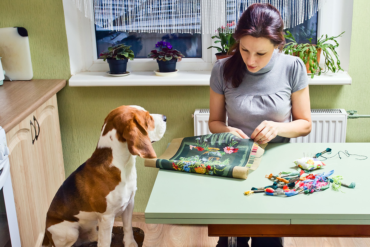 woman crafting with dog