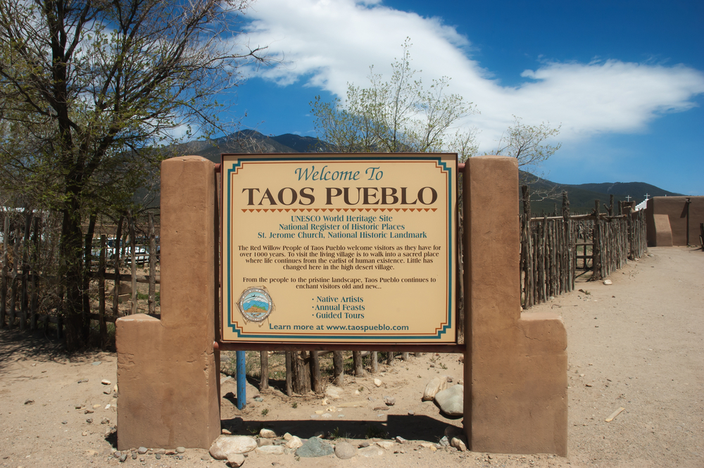 Taos Pueblo Sign at entrance to Taos Pueblo on April 30, 2011 in Taos, New Mexico. UNESCO World Heritage Site has been continuously inhabited for over 1000 years.
