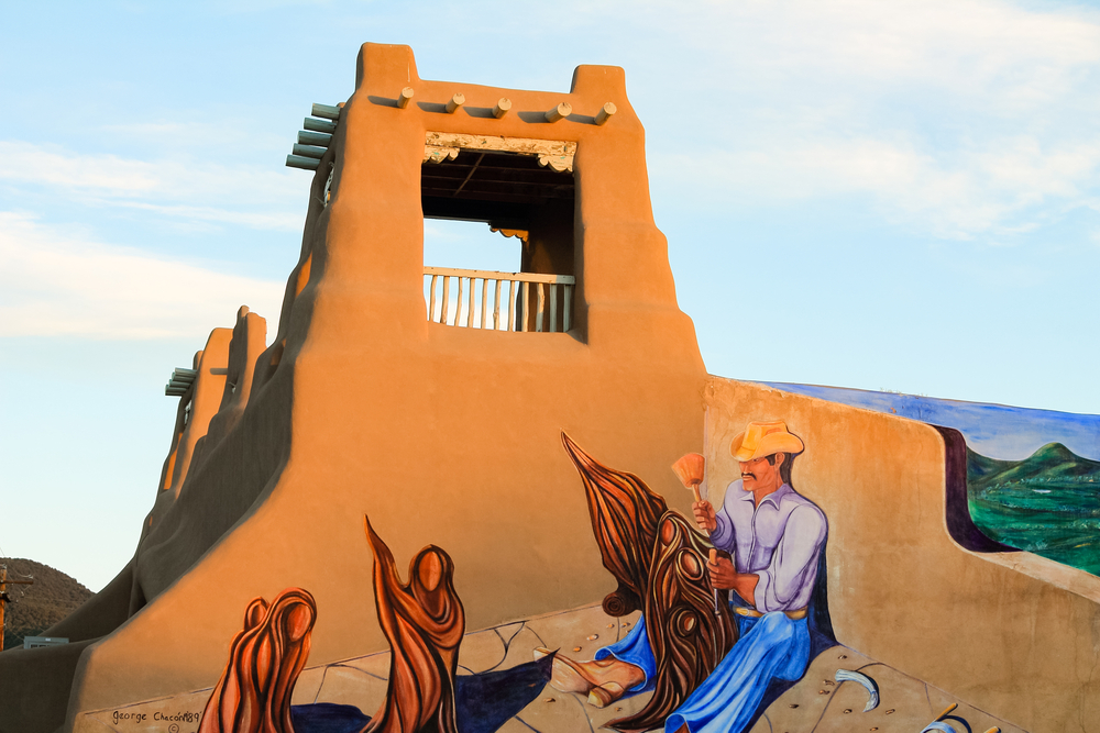 Detail of a mural of George Chacon of a typical building in the historic center of the town of Taos in New Mexico