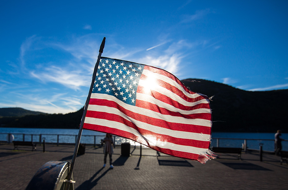 american flag over a lake