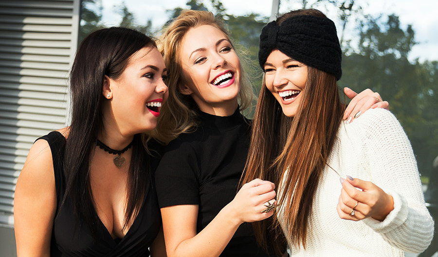 girl friends laughing sweaters