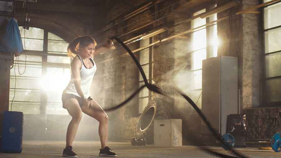 woman using ropes to exercise