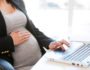 pregnant woman typing on computer