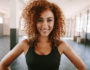 woman curly hair sports bra gym