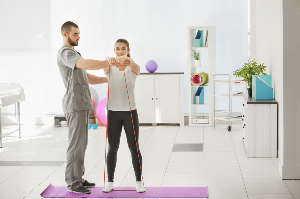 woman working with physical therapist