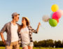 happy couple in love holding balloons