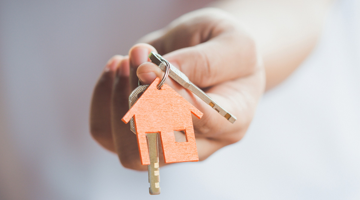 woman holding keys to new house